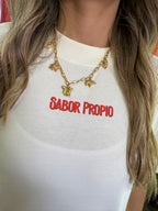 Camiseta Sabor Propio blanca con ilustración de frutas tropicales colombianas